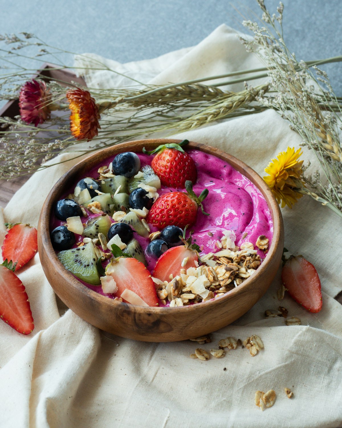 Fresh fruit bowl on stone in bright daylight
