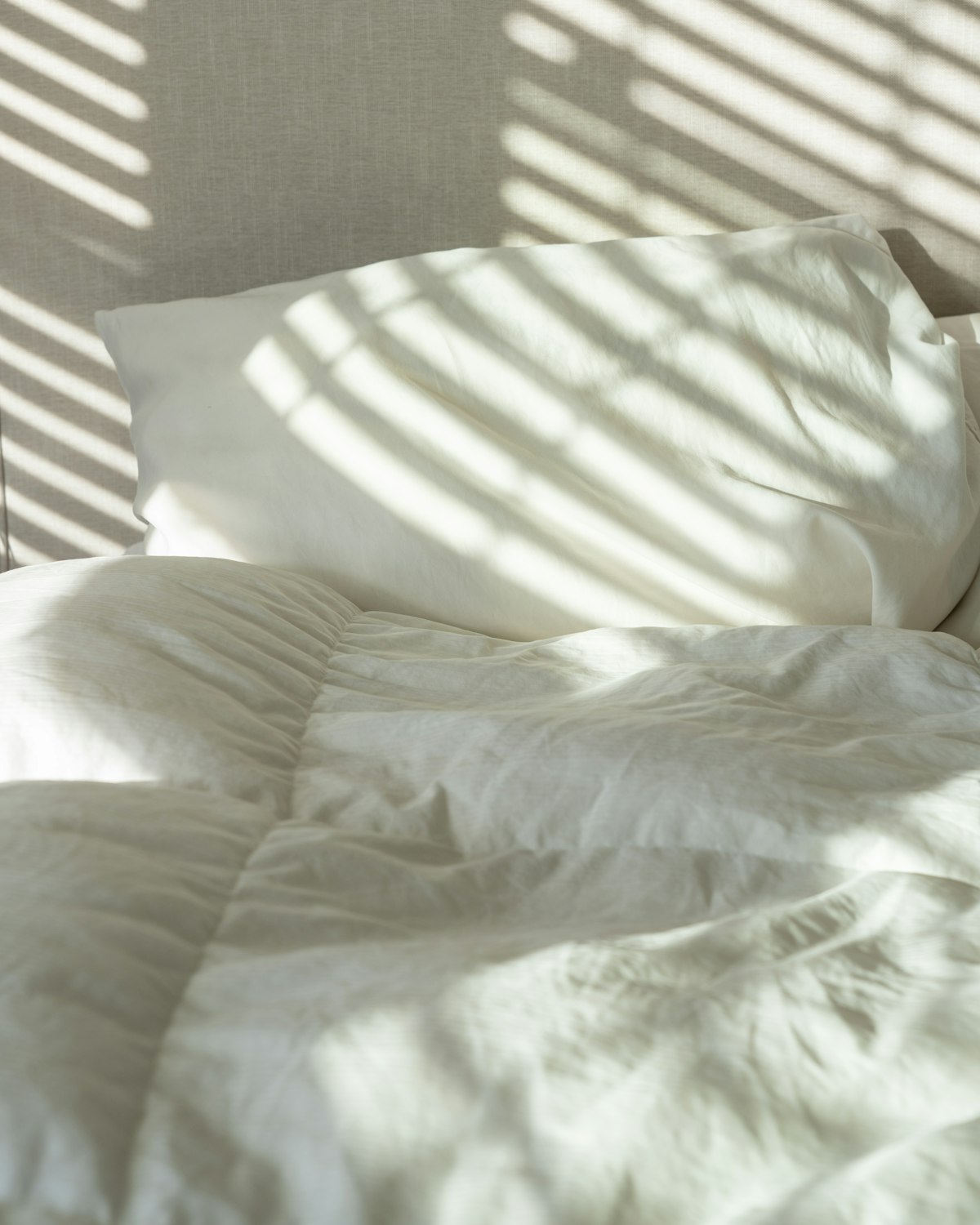 Morning light falling across white linen
